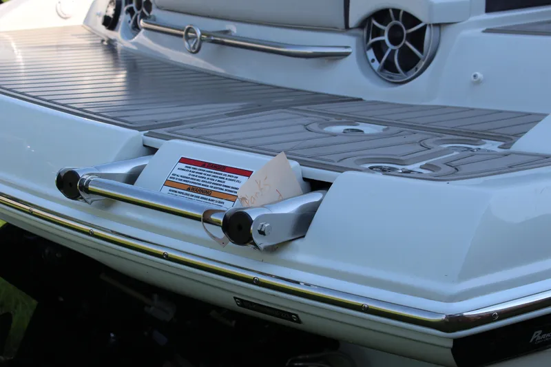 Slide: The Image of 2023 Crownline E285 boat swim platform with ladder and speaker detail. - 33