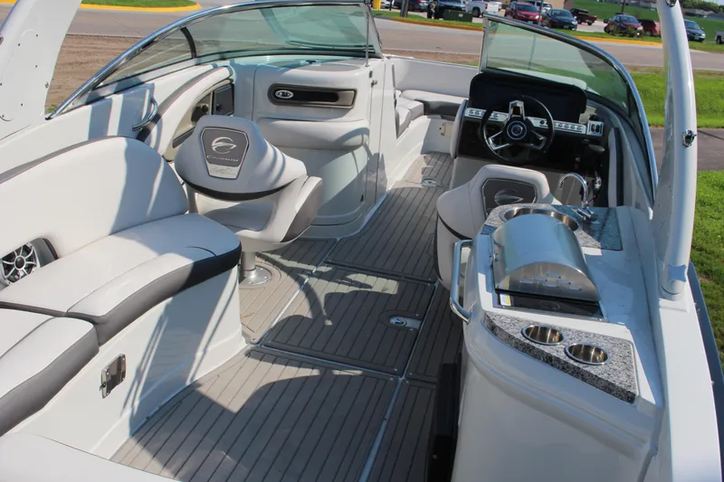 Slide: The Image of 2023 Crownline E285 boat interior with luxurious seating and modern amenities. - 35