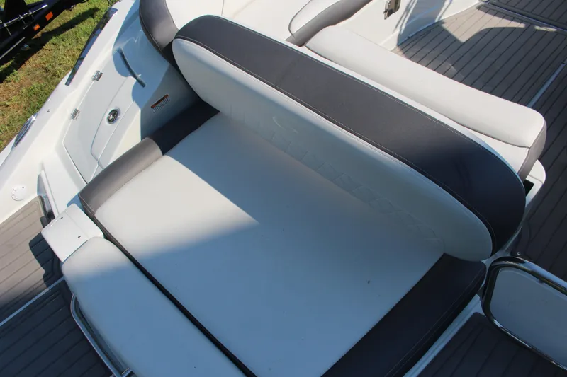 Slide: The Image of 2023 Crownline E285 boat seating area with gray and white upholstery. - 36