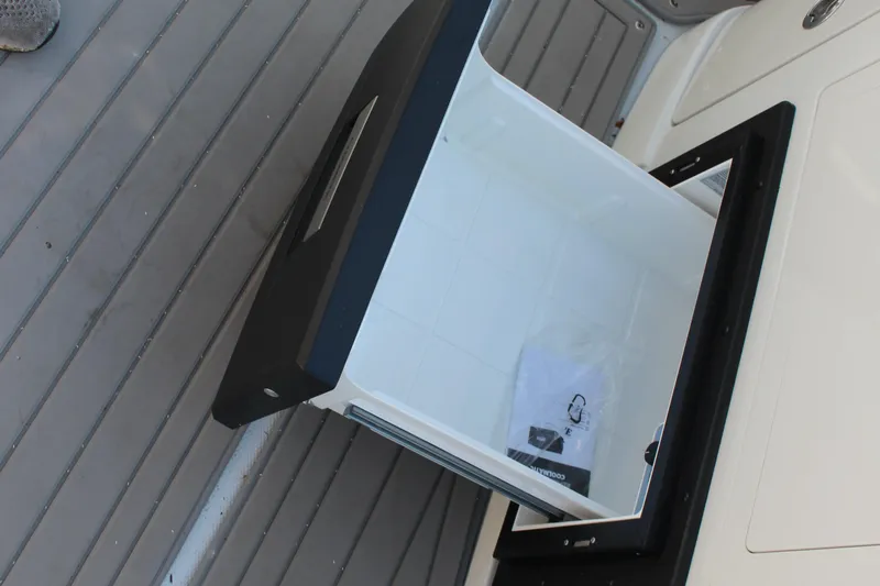 Slide: The Image of 2023 Crownline E285 boat storage compartment with open lid on deck. - 39