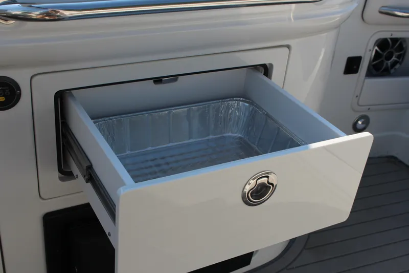 Slide: The Image of 2023 Crownline E285 boat with open storage drawer and aluminum tray. - 41