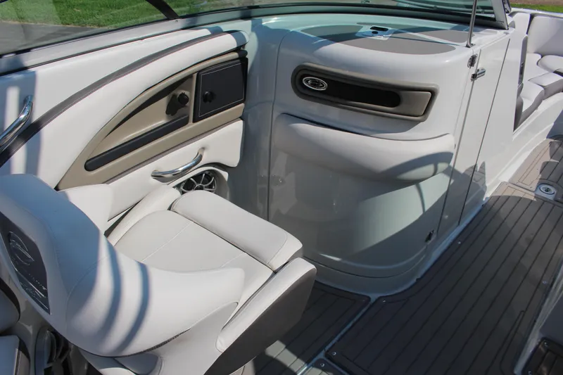 Slide: The Image of 2023 Crownline E285 boat interior with sleek seating and modern dashboard design. - 46