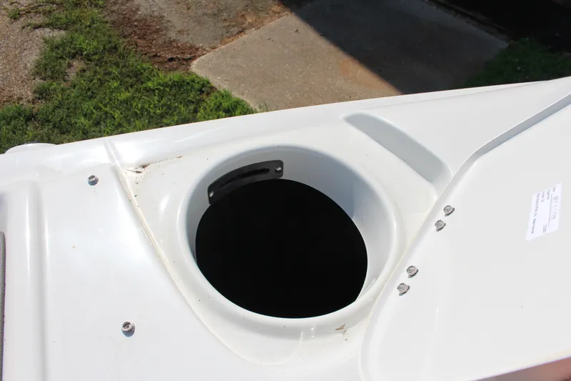 Slide: The Image of 2023 Crownline E285 boat storage compartment with open lid, showcasing interior space. - 52