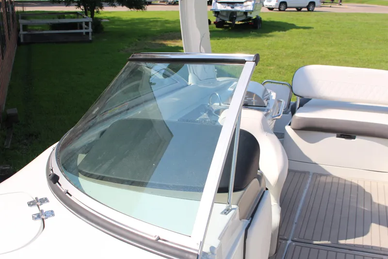 Slide: The Image of 2023 Crownline E285 boat interior with windshield and seating area. - 57