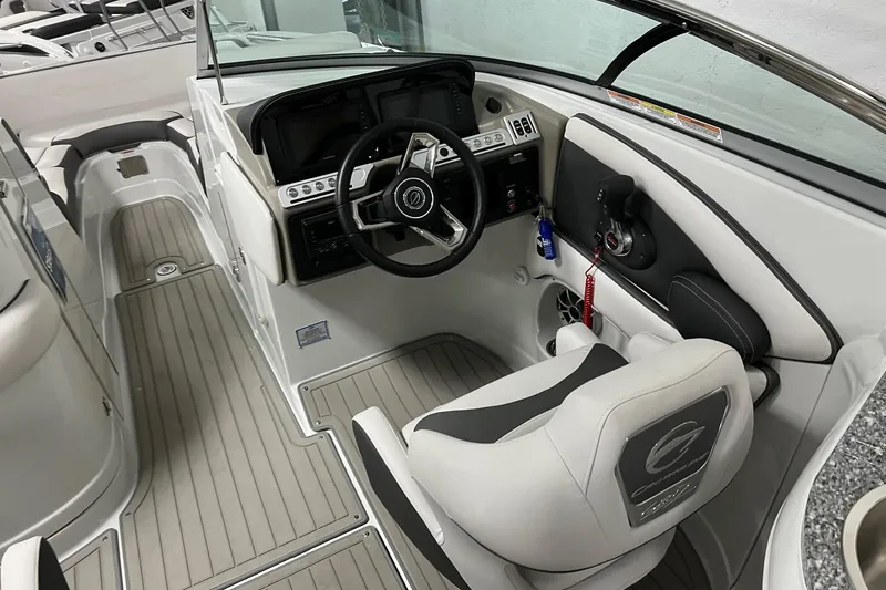 Slide: The Image of 2023 Crownline E285 boat interior with steering wheel and control panel. - 6