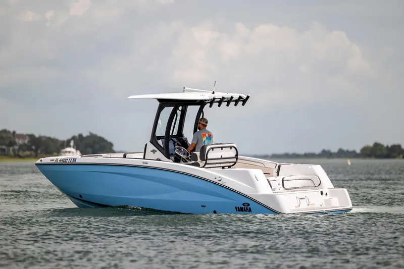 Slide: The Image of 2024 Yamaha Boats 255 FSH Sport H cruising on calm waters. - 0