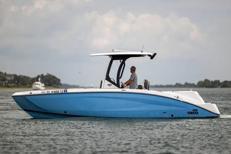 Slide: The Image of 2024 Yamaha Boats 255 FSH Sport H on calm water, side view. - 1
