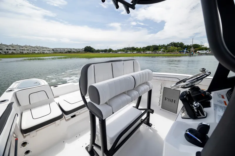 Slide: The Image of 2024 Yamaha Boats 255 FSH Sport H interior with sleek seating and steering console. - 11