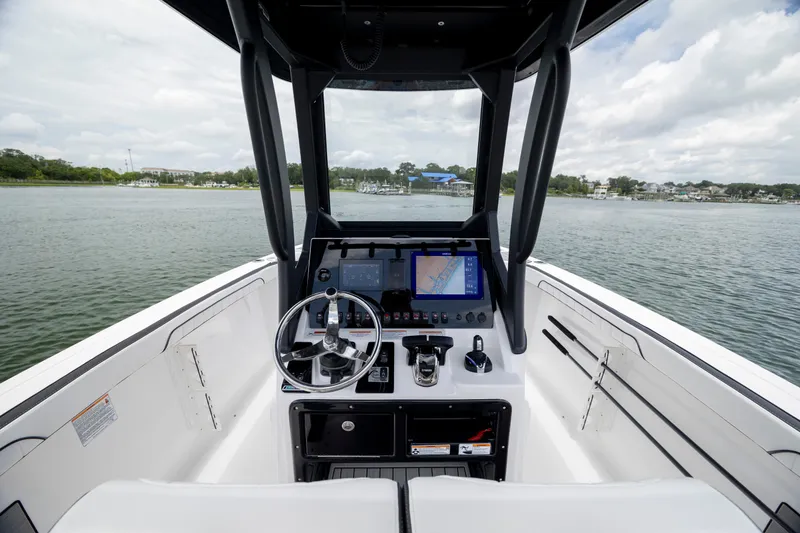 Slide: The Image of 2024 Yamaha Boats 255 FSH Sport H dashboard with steering wheel and navigation screen. - 13