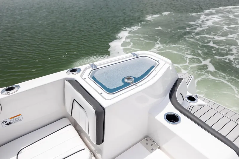 Slide: The Image of 2024 Yamaha Boats 255 FSH Sport H, rear deck view on water. - 18