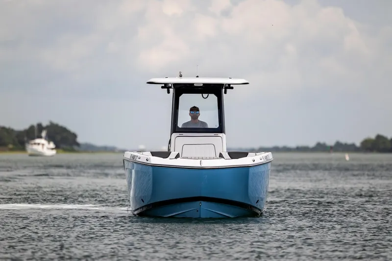 Slide: The Image of 2024 Yamaha Boats 255 FSH Sport H on calm water, front view. - 2