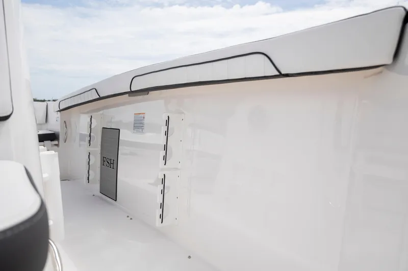 Slide: The Image of 2024 Yamaha Boats 255 FSH Sport H interior detail, showcasing sleek white design. - 23