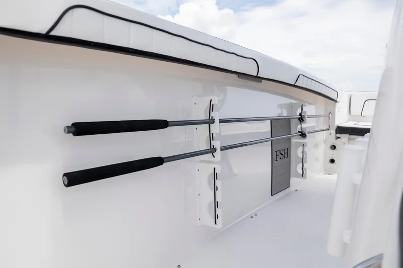 Slide: The Image of 2024 Yamaha Boats 255 FSH Sport H interior with rod holders and sleek design. - 26
