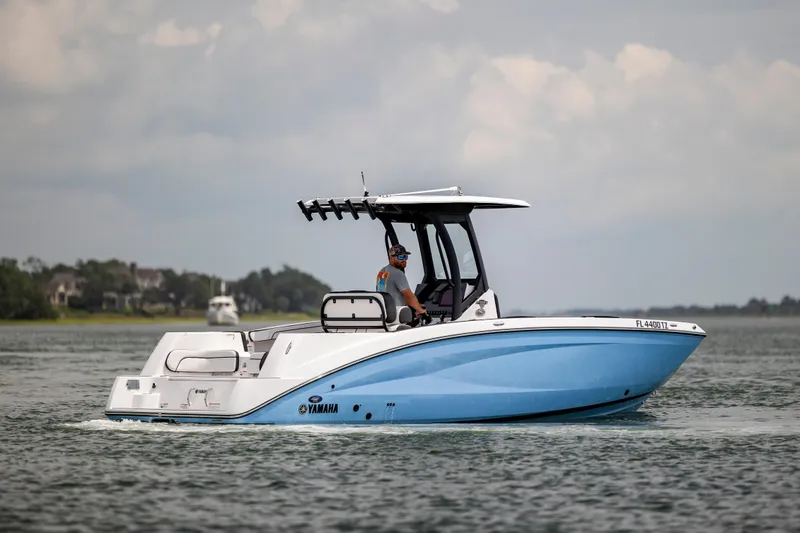 Slide: The Image of 2024 Yamaha Boats 255 FSH Sport H cruising on calm waters. - 4