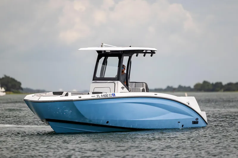 Slide: The Image of 2024 Yamaha Boats 255 FSH Sport H cruising on calm waters, side view. - 5