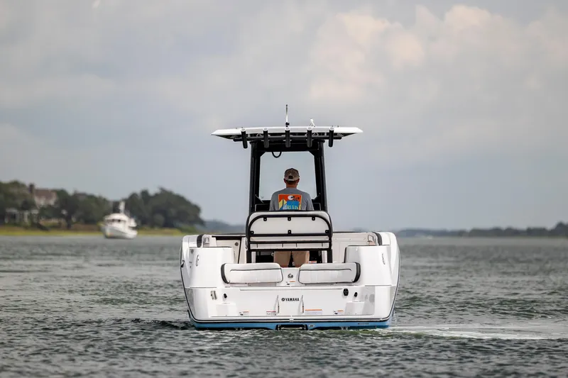 Slide: The Image of 2024 Yamaha Boats 255 FSH Sport H cruising on a calm waterway. - 6