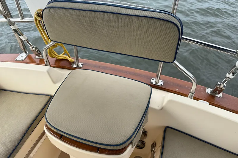 Slide: The Image of Cushioned seating on 2008 Island Packet 370 sailboat, overlooking water. - 12