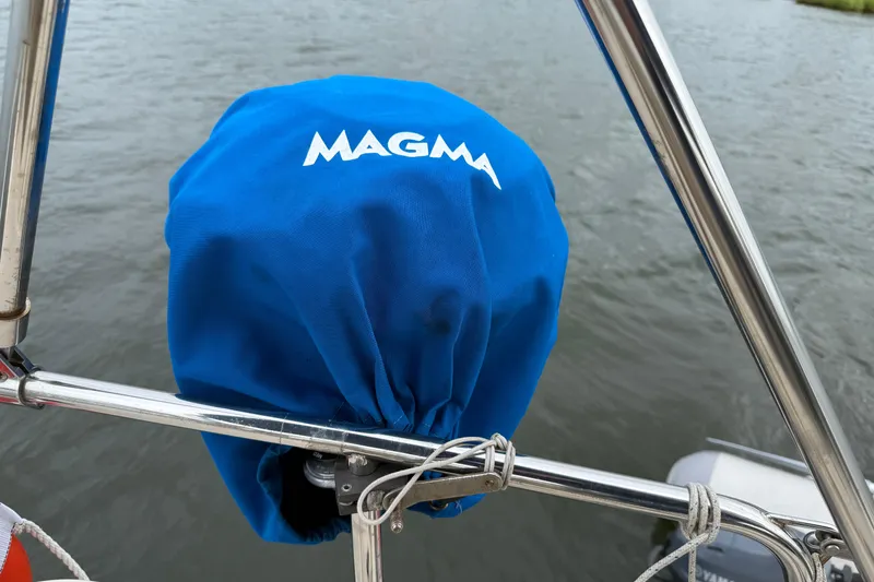 Slide: The Image of Blue Magma grill cover on Island Packet 370 sailboat, 2008 model, near water. - 13