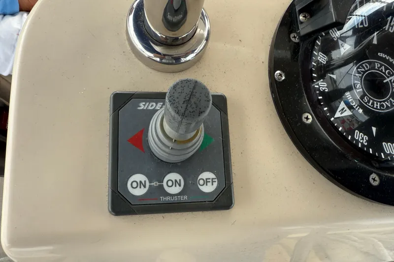Slide: The Image of Control panel of a 2008 Island Packet 370 sailboat with thruster joystick and compass. - 16