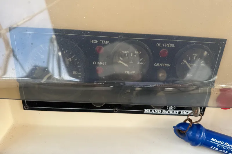 Slide: The Image of Control panel of a 2008 Island Packet 370 yacht with gauges and keychain. - 19