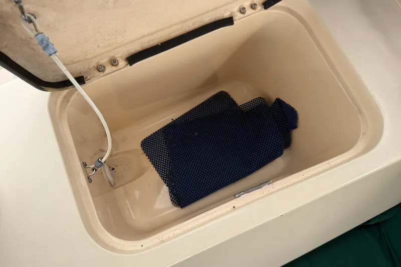 Slide: The Image of Open storage compartment on 2008 Island Packet 370 sailboat with blue mat inside. - 23