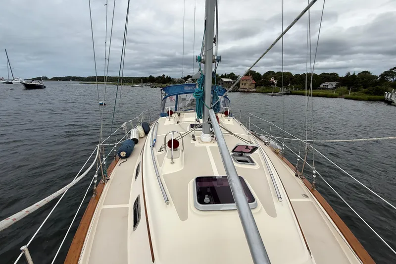 Slide: The Image of 2008 Island Packet 370 sailboat on calm waters, showcasing deck and rigging. - 34