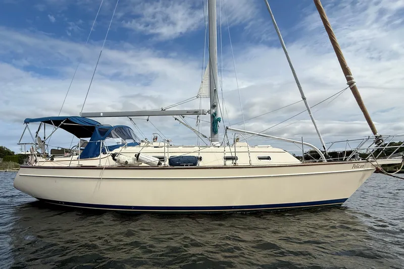 Slide: The Image of 2008 Island Packet 370 sailboat on water under cloudy sky. - 4