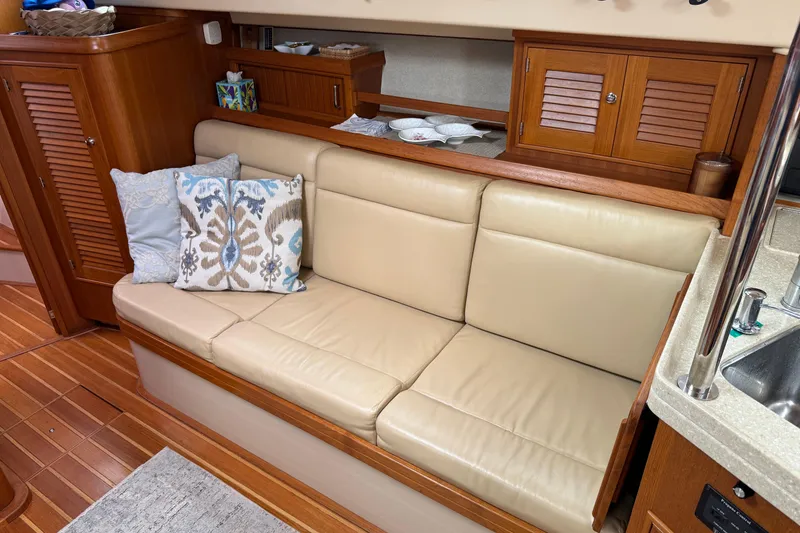 Slide: The Image of Interior of 2008 Island Packet 370 yacht with beige leather seating and decorative pillows. - 40