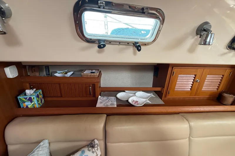 Slide: The Image of Interior of 2008 Island Packet 370 yacht with wooden cabinets and porthole window. - 45