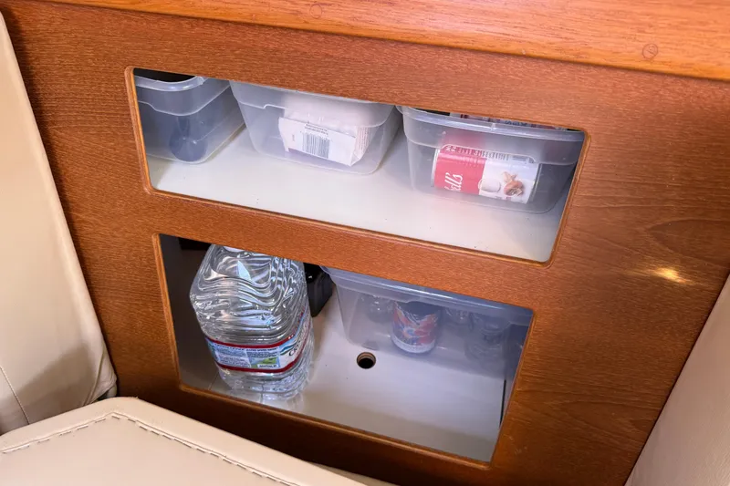 Slide: The Image of Storage compartments on 2008 Island Packet 370 yacht, featuring organized containers and bottled water. - 47