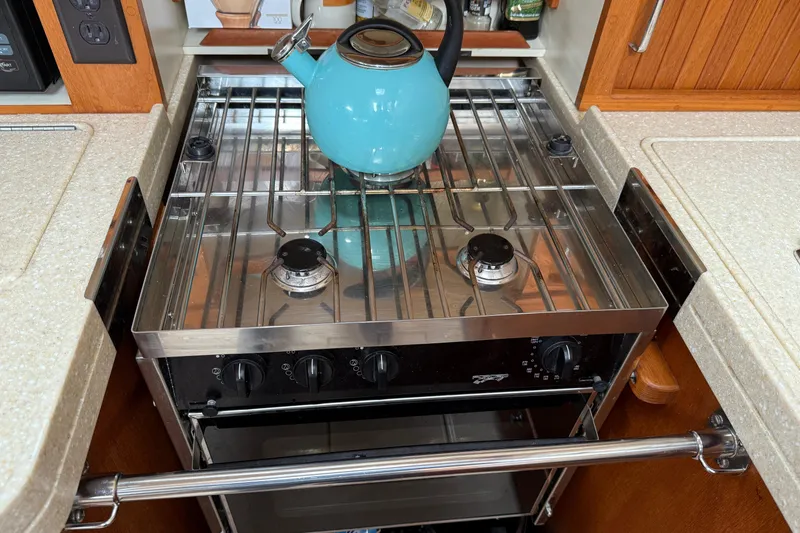 Slide: The Image of Stove with blue kettle in 2008 Island Packet 370 yacht kitchen. - 52