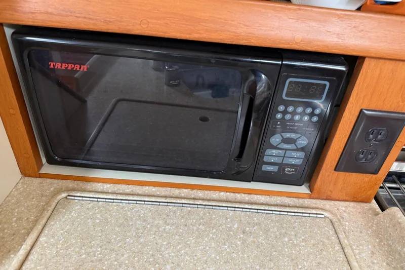 Slide: The Image of Tappan microwave in 2008 Island Packet 370 yacht kitchen, featuring wood trim and countertop. - 54