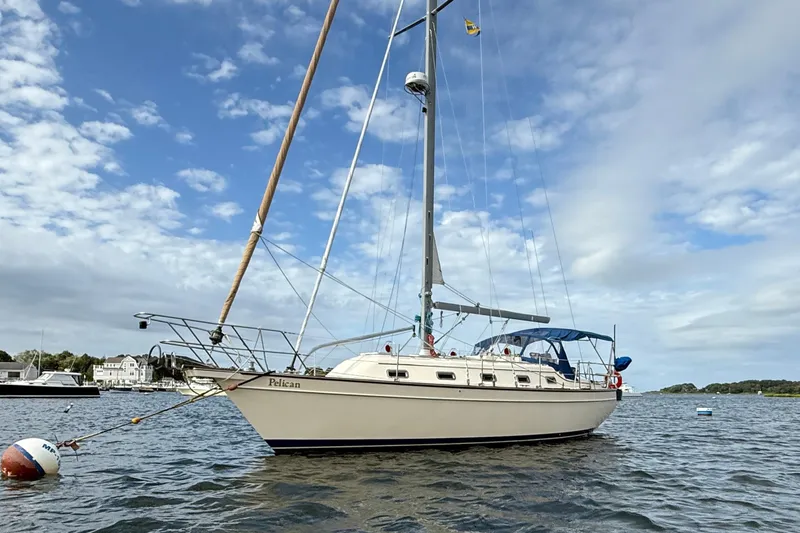 Slide: The Image of 2008 Island Packet 370 sailboat anchored on a calm, scenic waterway. - 6