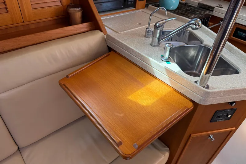 Slide: The Image of Interior of 2008 Island Packet 370 yacht with wooden table and kitchen sink. - 60