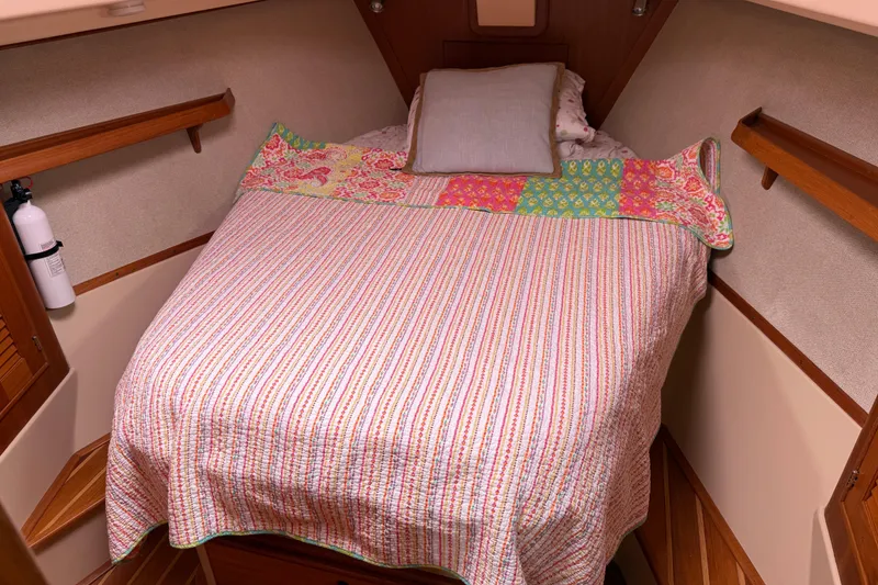 Slide: The Image of Cozy cabin interior of 2008 Island Packet 370 sailboat with colorful bedding. - 62
