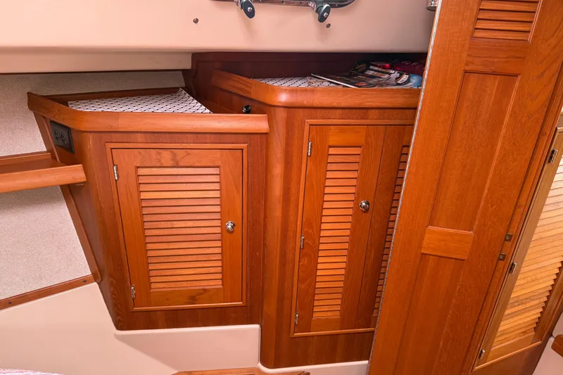Slide: The Image of 2008 Island Packet 370 interior with wooden cabinets and storage space. - 63