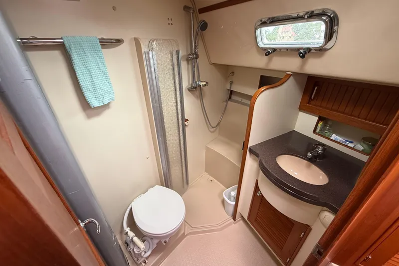 Slide: The Image of 2008 Island Packet 370 yacht bathroom with shower, sink, and toilet. - 67