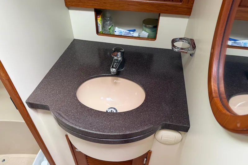 Slide: The Image of Bathroom sink area on a 2008 Island Packet 370 yacht, featuring a sleek countertop. - 68