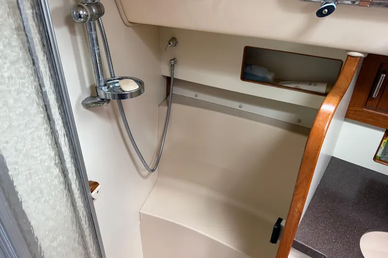 Slide: The Image of 2008 Island Packet 370 yacht bathroom with shower and wooden accents. - 70