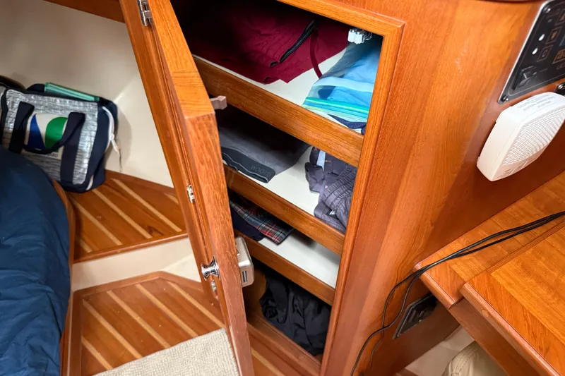 Slide: The Image of Interior of 2008 Island Packet 370 sailboat with wooden cabinetry and storage shelves. - 72