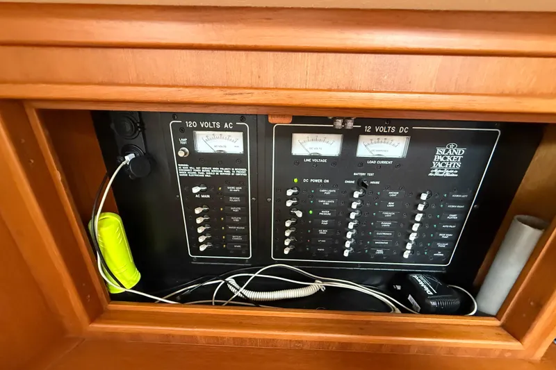 Slide: The Image of Electrical panel of a 2008 Island Packet 370 yacht, featuring 120V AC and 12V DC systems. - 76