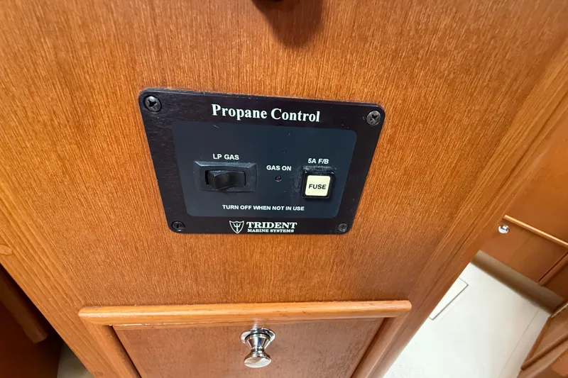 Slide: The Image of Propane control panel on 2008 Island Packet 370 yacht, featuring LP gas switch and fuse. - 79