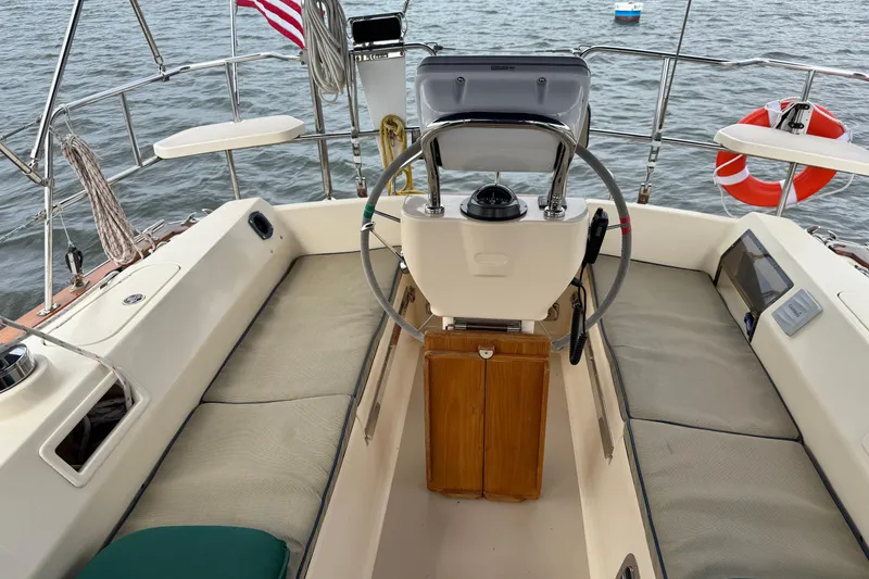 Slide: The Image of Cockpit of 2008 Island Packet 370 sailboat with steering wheel and seating. - 9