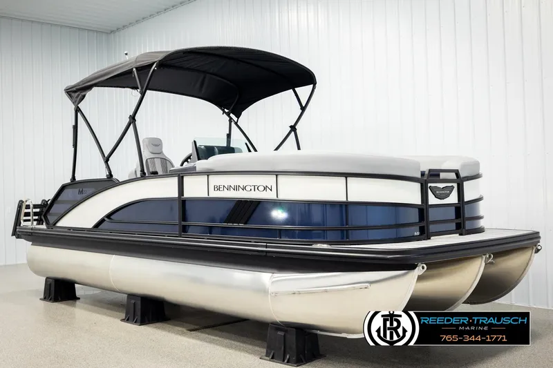 Slide: The Image of 2026 Bennington 22 MSBSE pontoon boat with canopy in showroom. - 3
