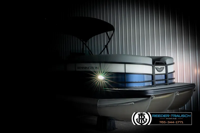 Slide: The Image of 2026 Bennington 22 MSBSE pontoon boat with illuminated front, showcased in a dimly lit setting. - 4