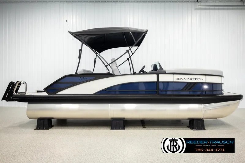 Slide: The Image of 2026 Bennington 22 MSBSE pontoon boat with canopy in showroom. - 5