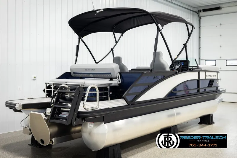 Slide: The Image of 2026 Bennington 22 MSBSE pontoon boat with canopy in showroom. - 6