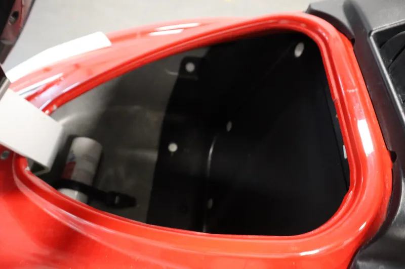 Slide: The Image of Open storage compartment of 2018 Yamaha GP1800, featuring red trim and visible interior. - 10