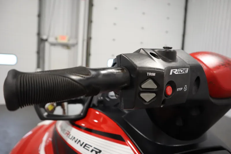 Slide: The Image of Close-up of 2018 Yamaha GP1800 handlebar controls, featuring trim and stop buttons. - 14