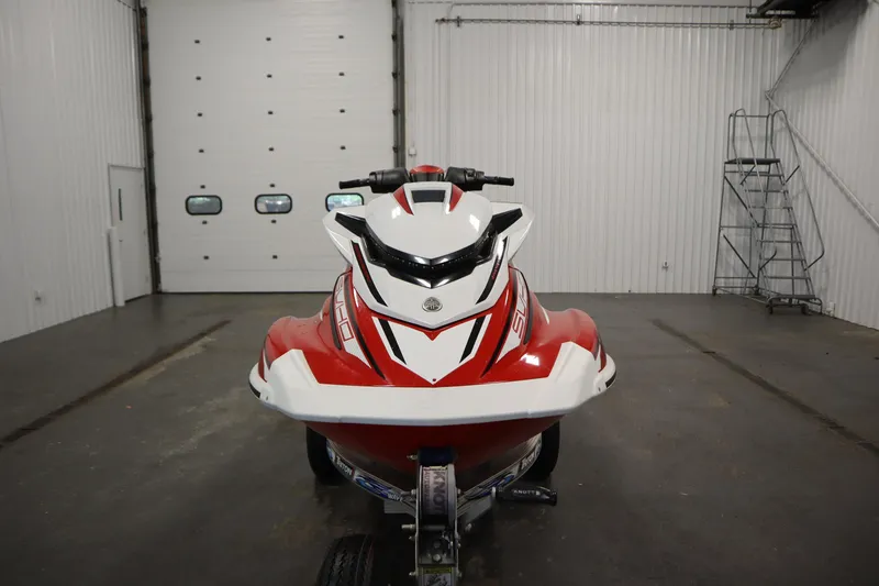 Slide: The Image of 2018 Yamaha GP1800 jet ski in a garage, front view, red and white design. - 2